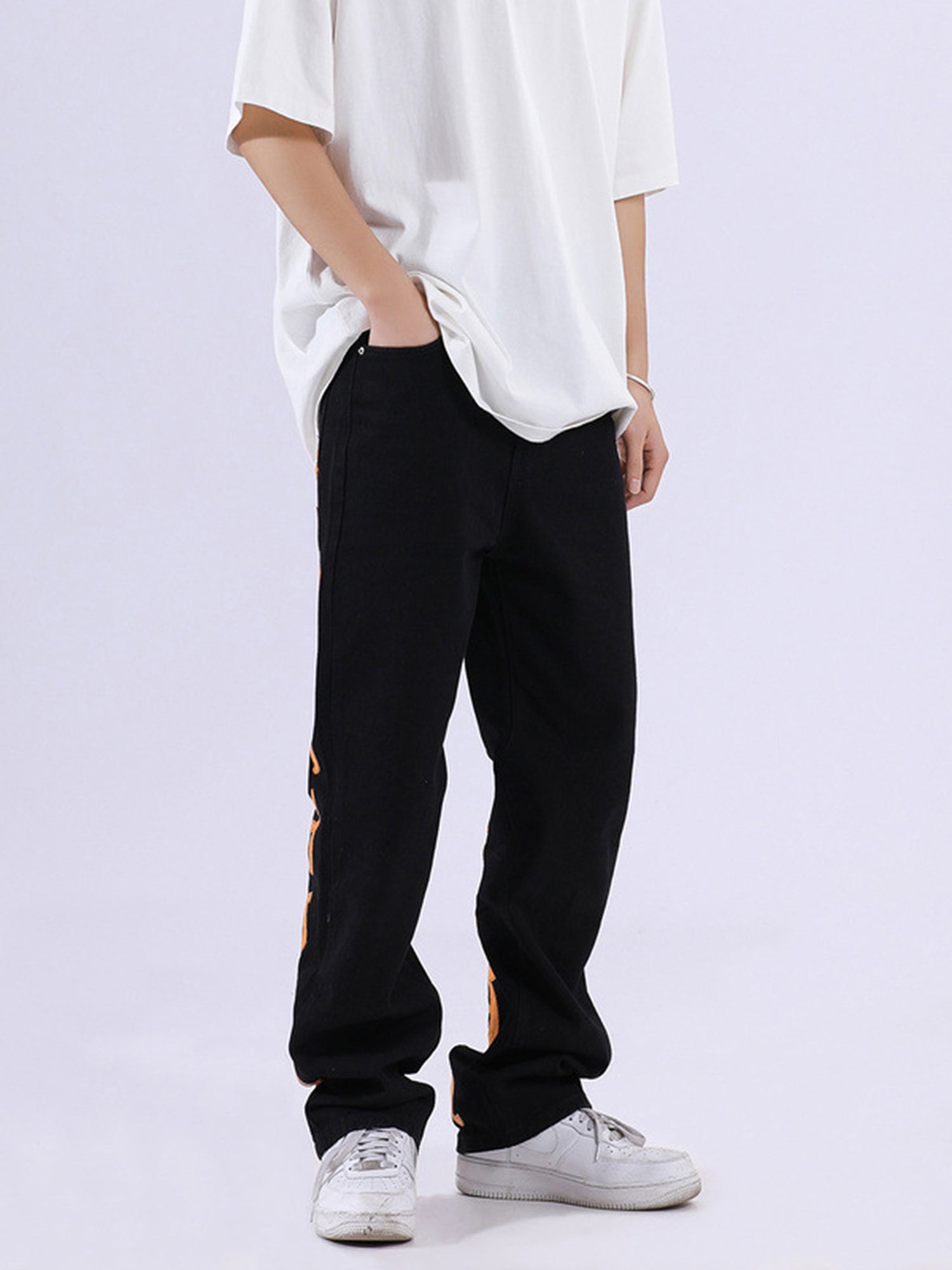 BLACK JEANS WITH ORANGE GOTHIC LETTERING FASHION STATEMENT APPAREL