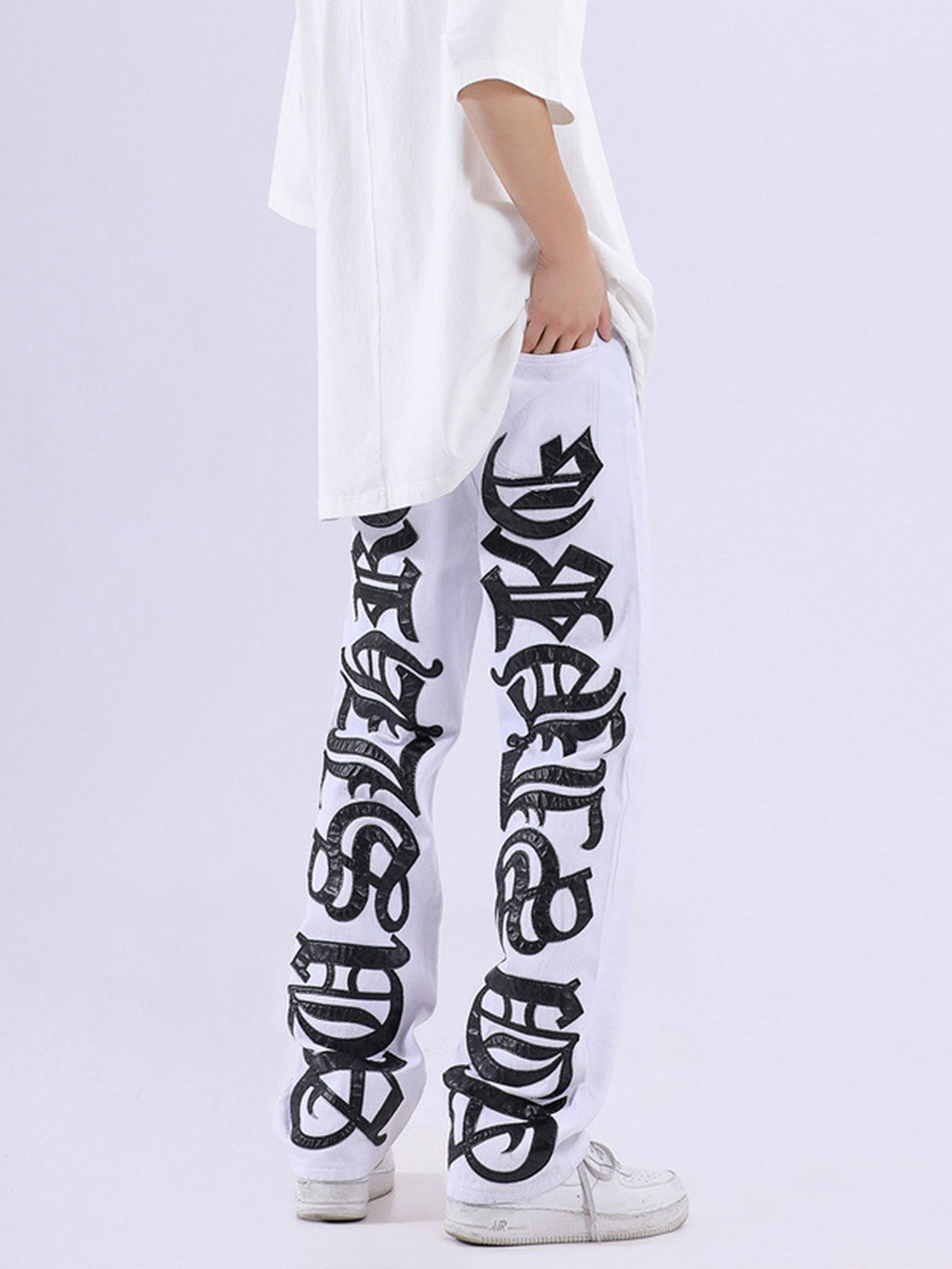 BLACK JEANS WITH ORANGE GOTHIC LETTERING FASHION STATEMENT APPAREL