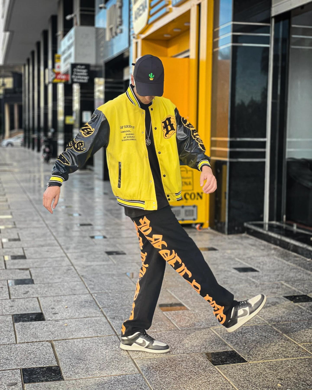 BLACK JEANS WITH ORANGE GOTHIC LETTERING FASHION STATEMENT APPAREL