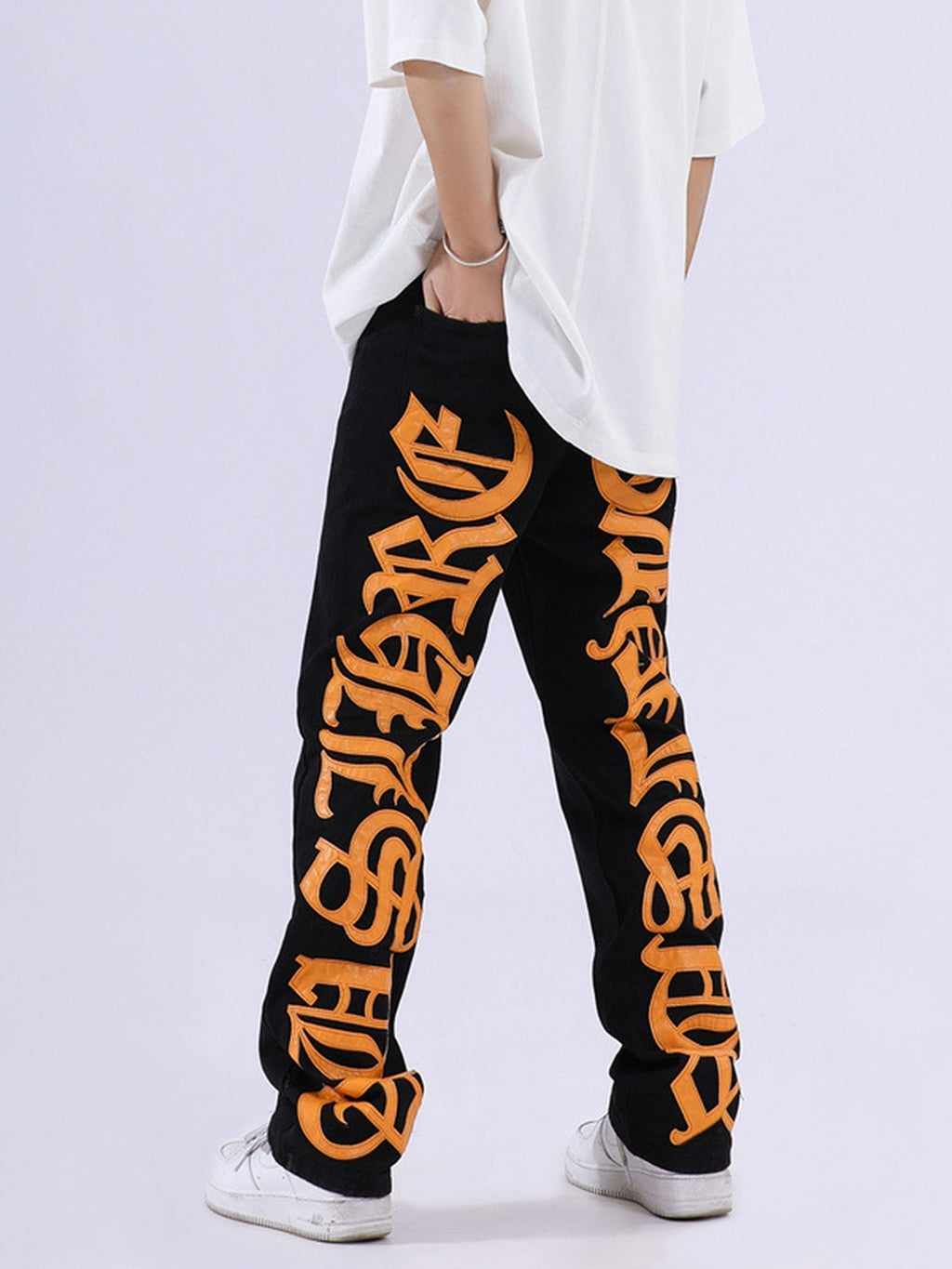 BLACK JEANS WITH ORANGE GOTHIC LETTERING FASHION STATEMENT APPAREL