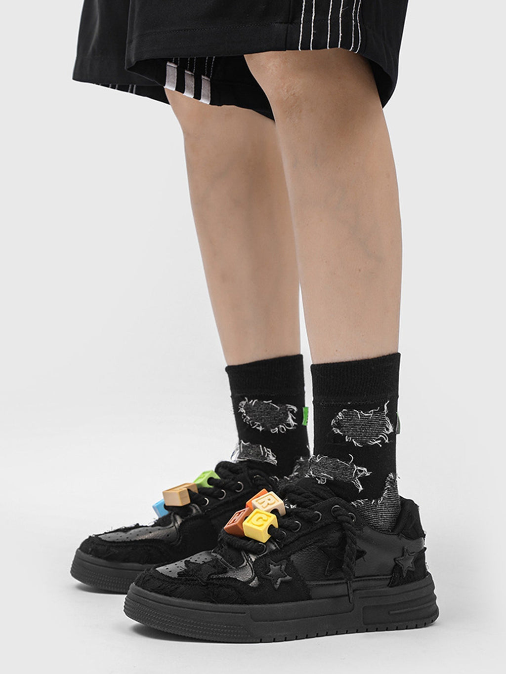 BLACK STAR-ACCENTED SNEAKERS FOR RETRO DARTH VADER ENTHUSIASTS