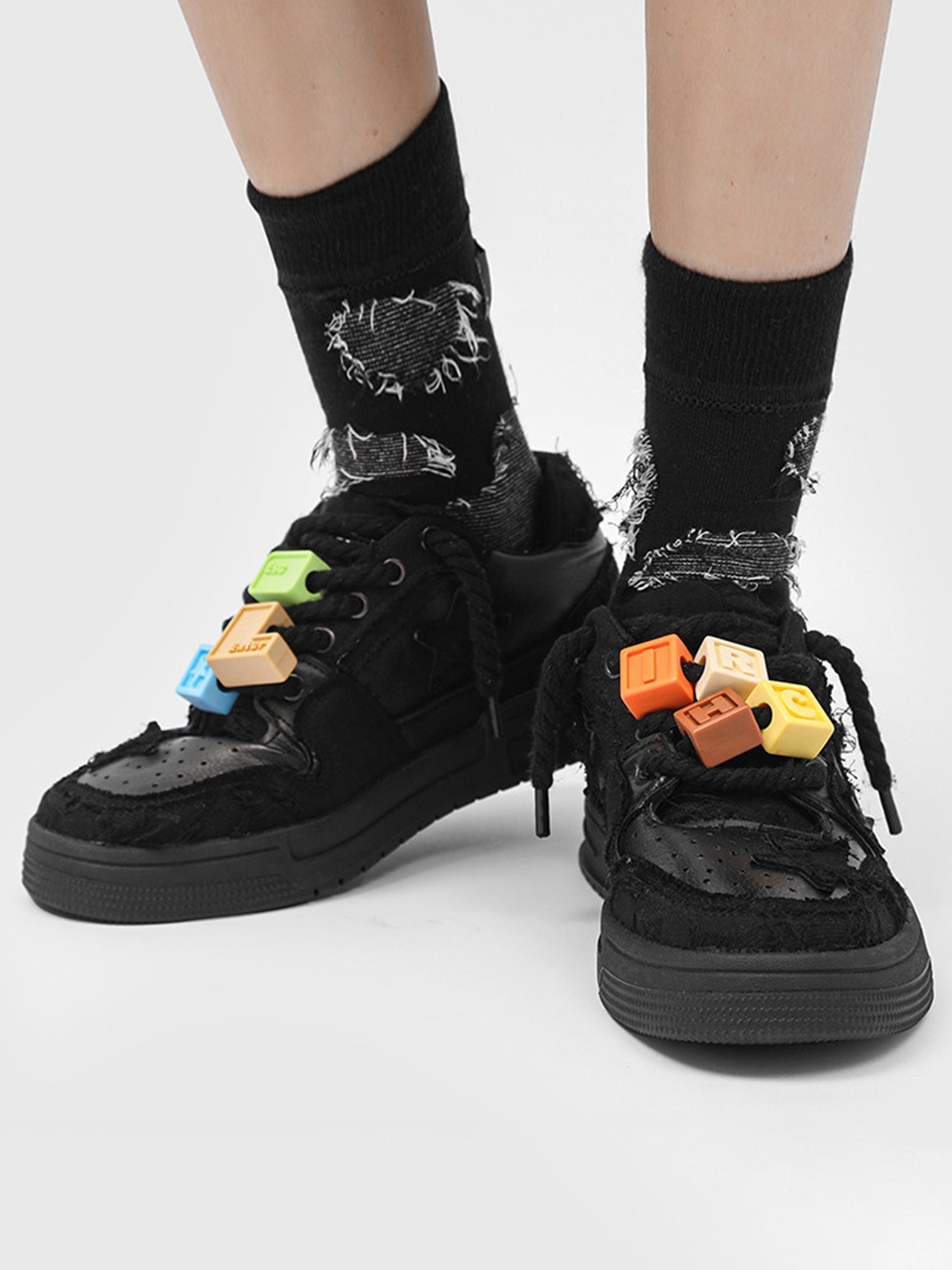 BLACK STAR-ACCENTED SNEAKERS FOR RETRO DARTH VADER ENTHUSIASTS
