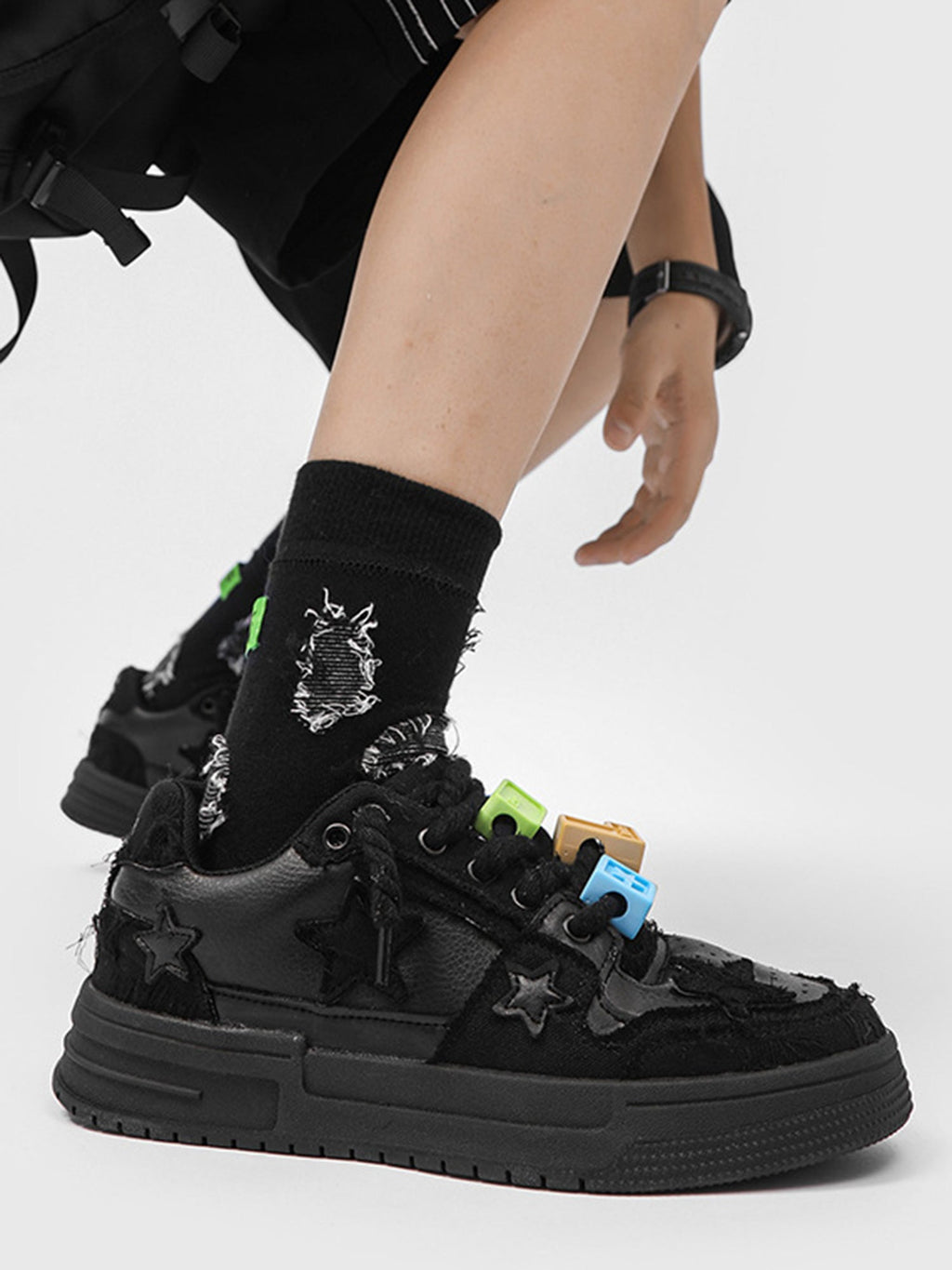 BLACK STAR-ACCENTED SNEAKERS FOR RETRO DARTH VADER ENTHUSIASTS