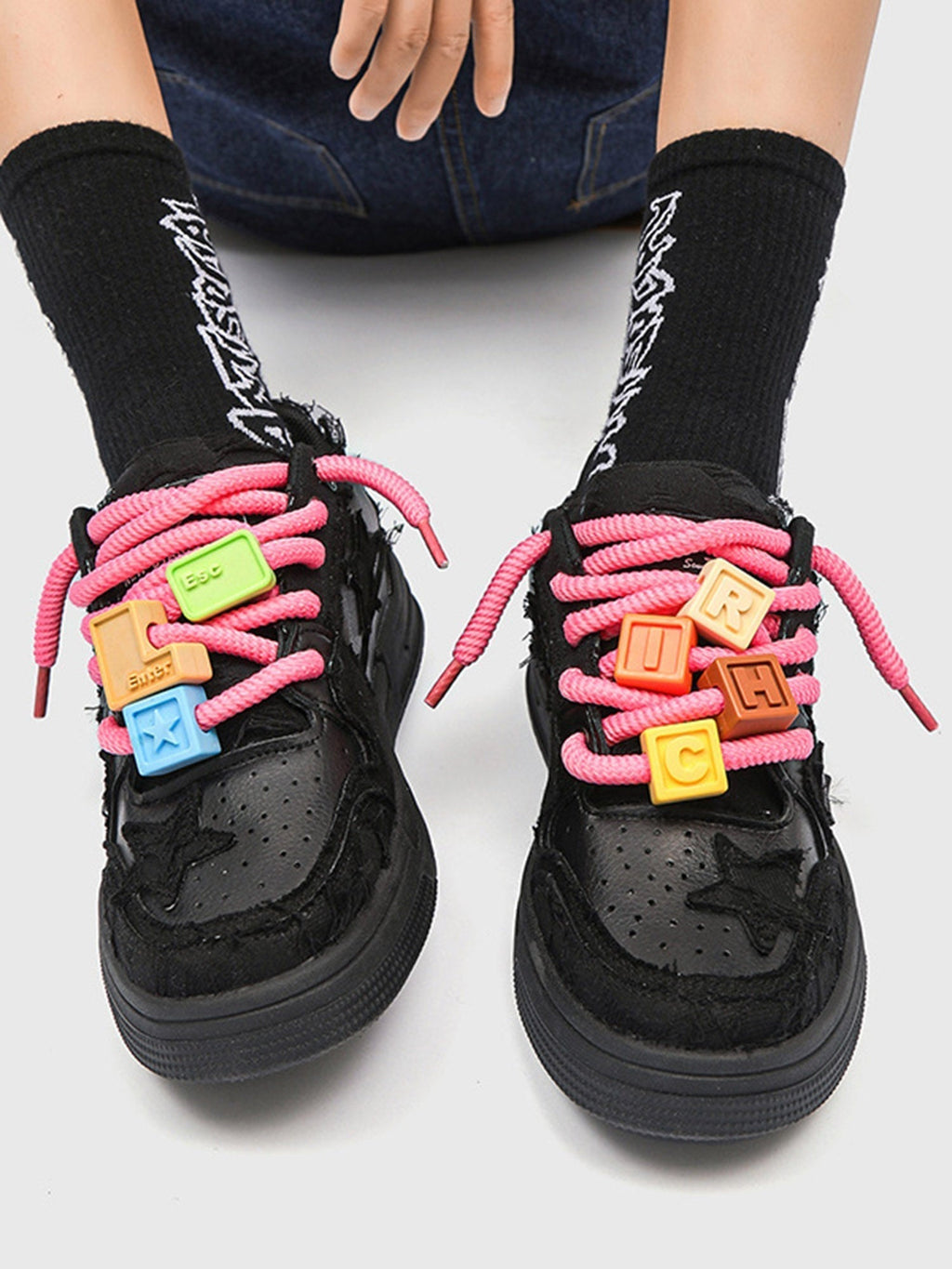 BLACK STAR-ACCENTED SNEAKERS FOR RETRO DARTH VADER ENTHUSIASTS