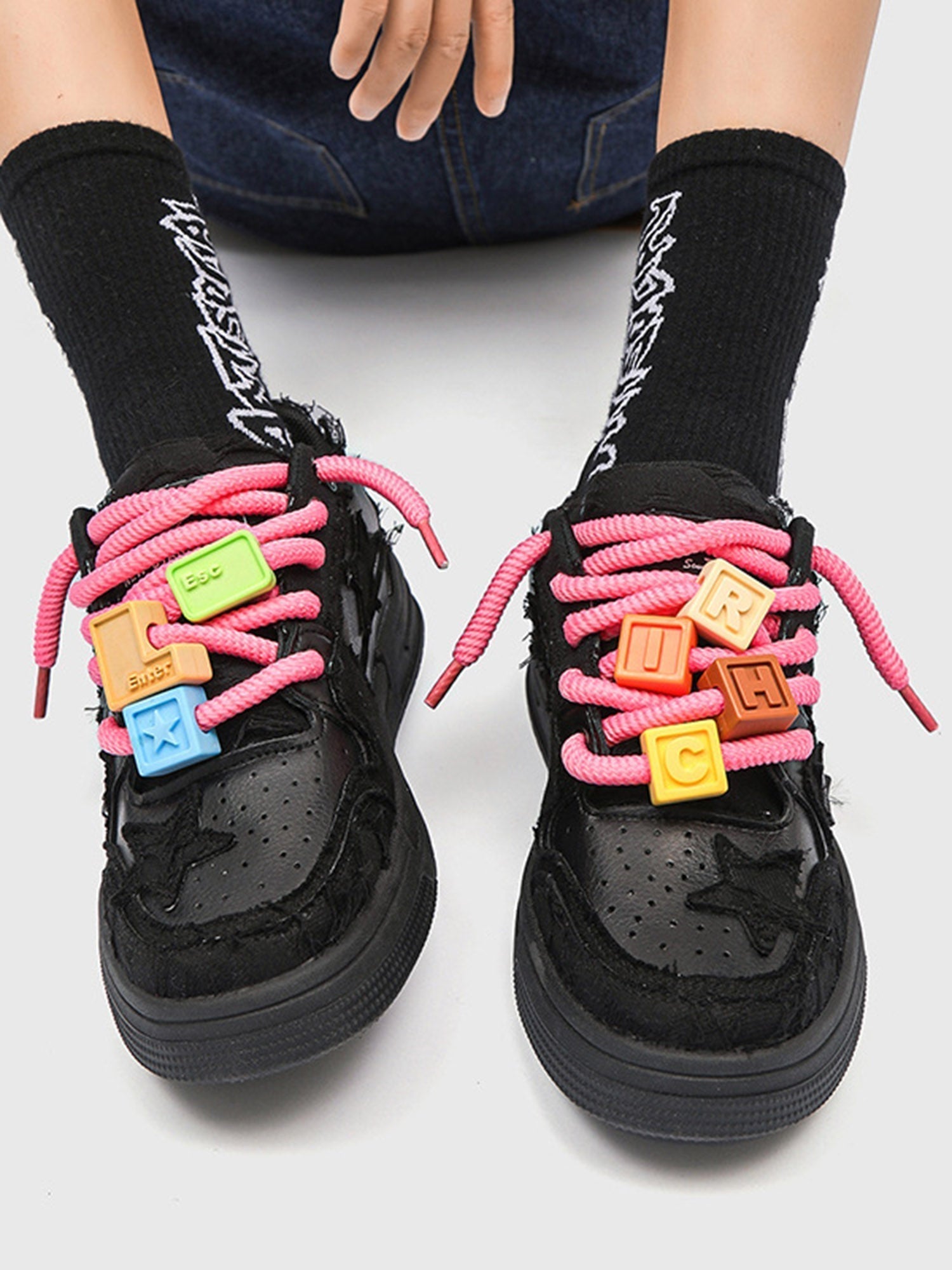 BLACK STAR-ACCENTED SNEAKERS FOR RETRO DARTH VADER ENTHUSIASTS