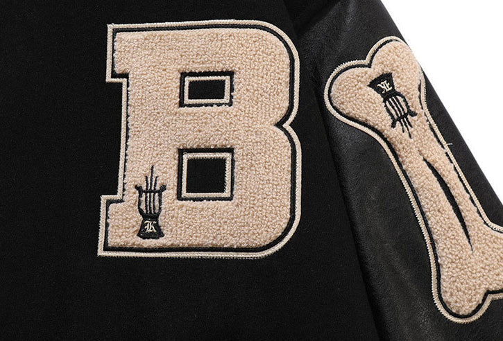 BLACK VARSITY JACKET WITH BONE SLEEVES CETTE VESTE EST CHIC