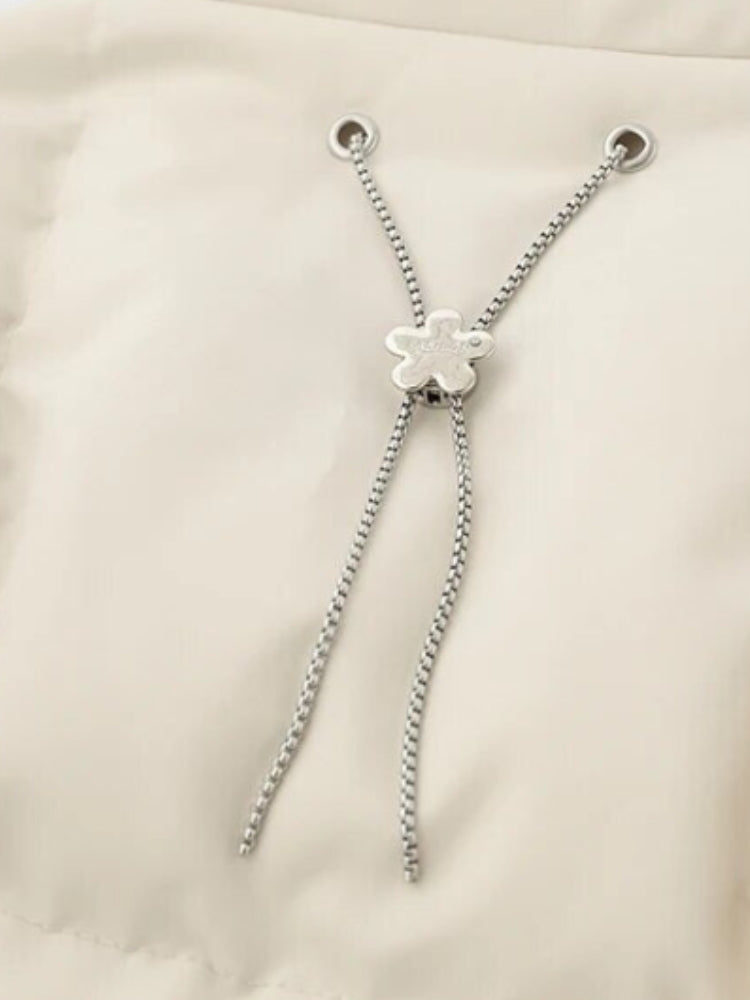 BLACK PUFFER JACKET WITH WHITE ACCENTS FOR COLD WEATHER WEAR