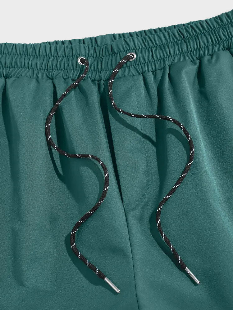 GREEN DRAWSTRING SHORTS WITH GREEN LABEL DESIGN
