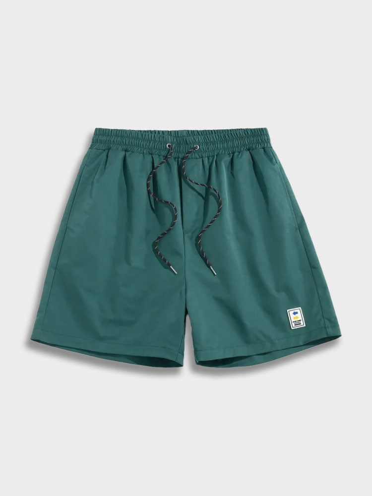 GREEN DRAWSTRING SHORTS WITH GREEN LABEL DESIGN
