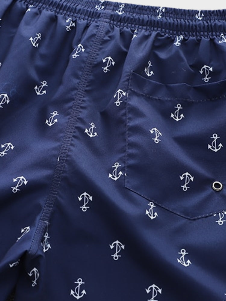 NAVY BLUE ANCHOR-PATTERNED SWIM TRUNKS WITH COMFORTABLE STRETCH FIT