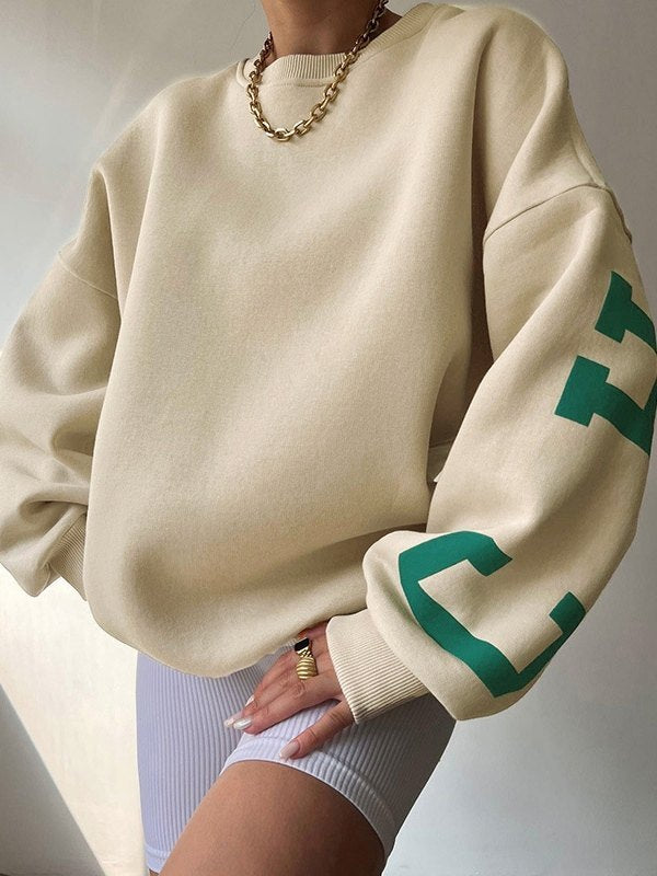 OVERSIZED BEIGE LONG SLEEVE CREW SWEATSHIRT WITH GREEN LETTERING