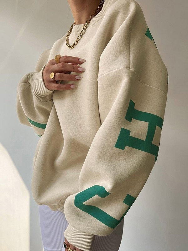 OVERSIZED BEIGE LONG SLEEVE CREW SWEATSHIRT WITH GREEN LETTERING