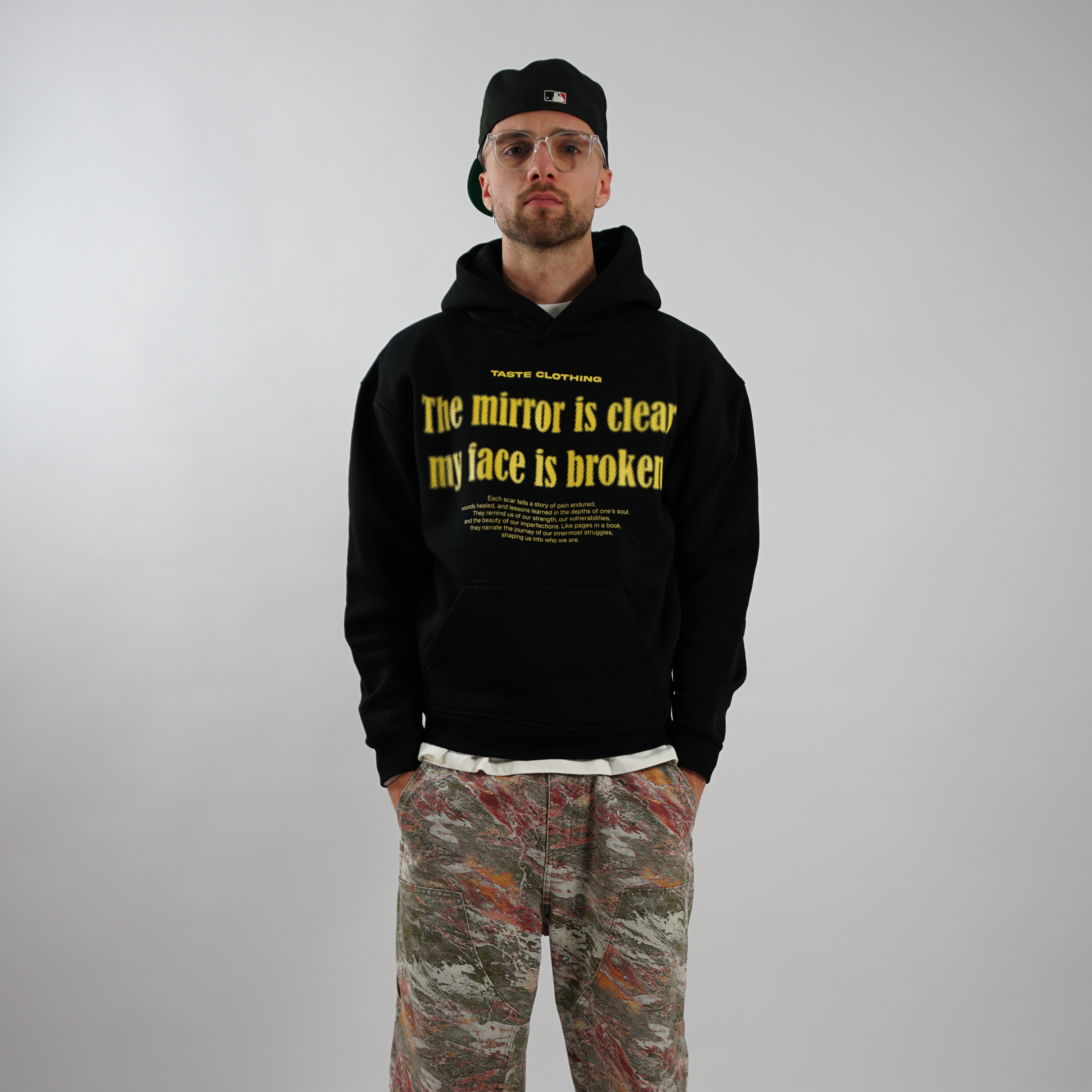 OVERSIZED FIT BLACK HOODIE WITH PRINTED POCKET AND YELLOW TEXT