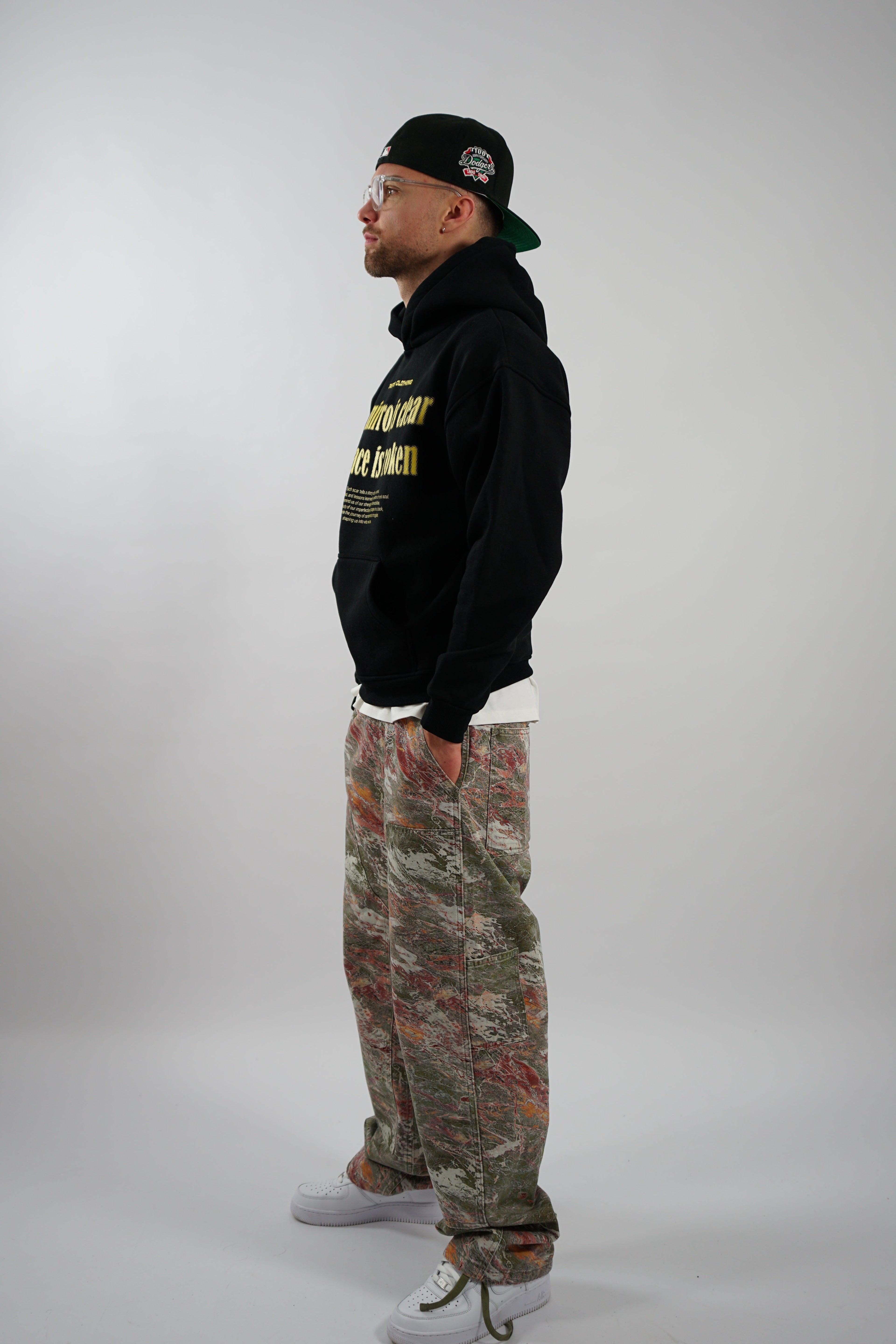 OVERSIZED FIT BLACK HOODIE WITH PRINTED POCKET AND YELLOW TEXT