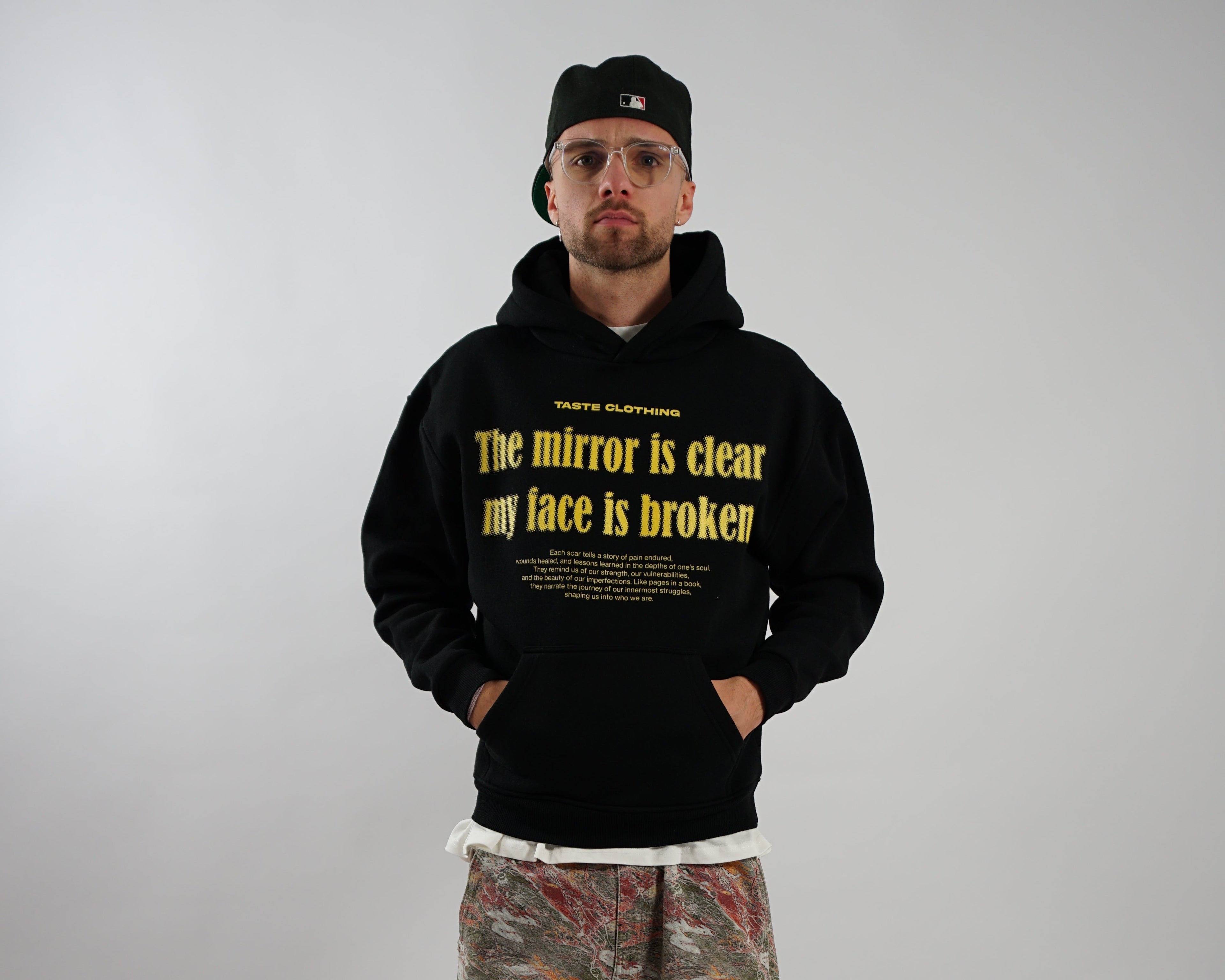 OVERSIZED FIT BLACK HOODIE WITH PRINTED POCKET AND YELLOW TEXT