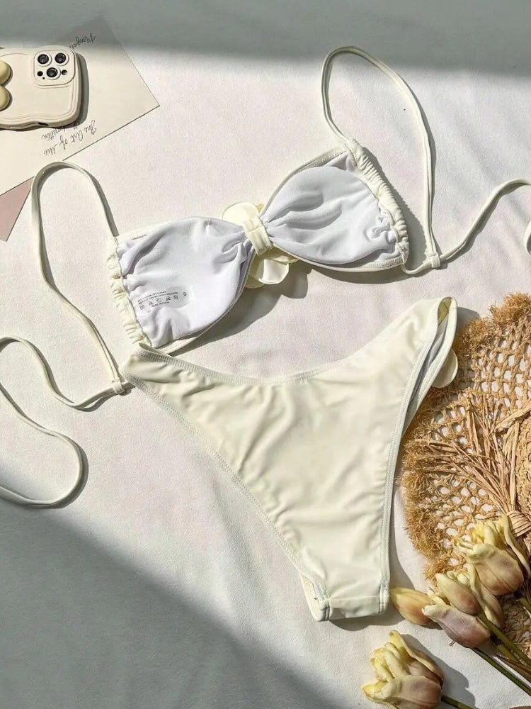 TWO-PIECE BROWN SWIMSUIT WITH WHITE FLOWER ACCENTS AND SIZE GUIDE