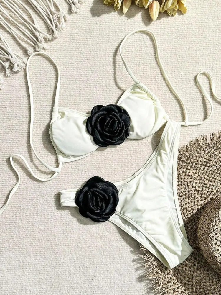 TWO-PIECE BROWN SWIMSUIT WITH WHITE FLOWER ACCENTS AND SIZE GUIDE