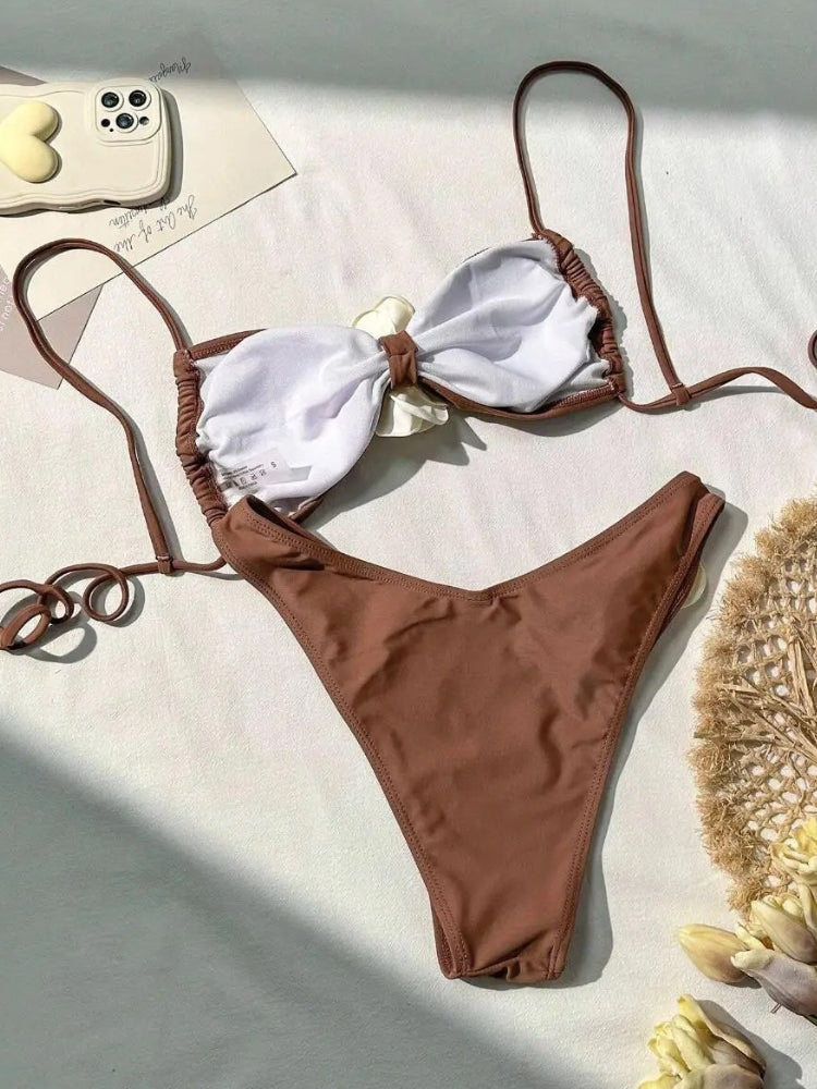 TWO-PIECE BROWN SWIMSUIT WITH WHITE FLOWER ACCENTS AND SIZE GUIDE