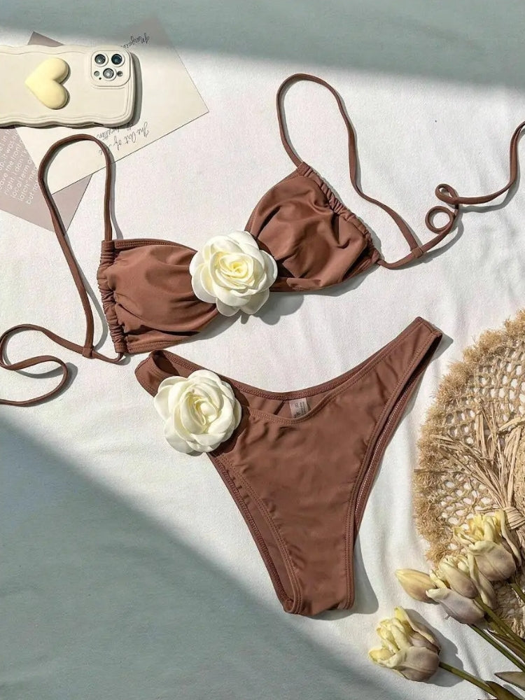 TWO-PIECE BROWN SWIMSUIT WITH WHITE FLOWER ACCENTS AND SIZE GUIDE