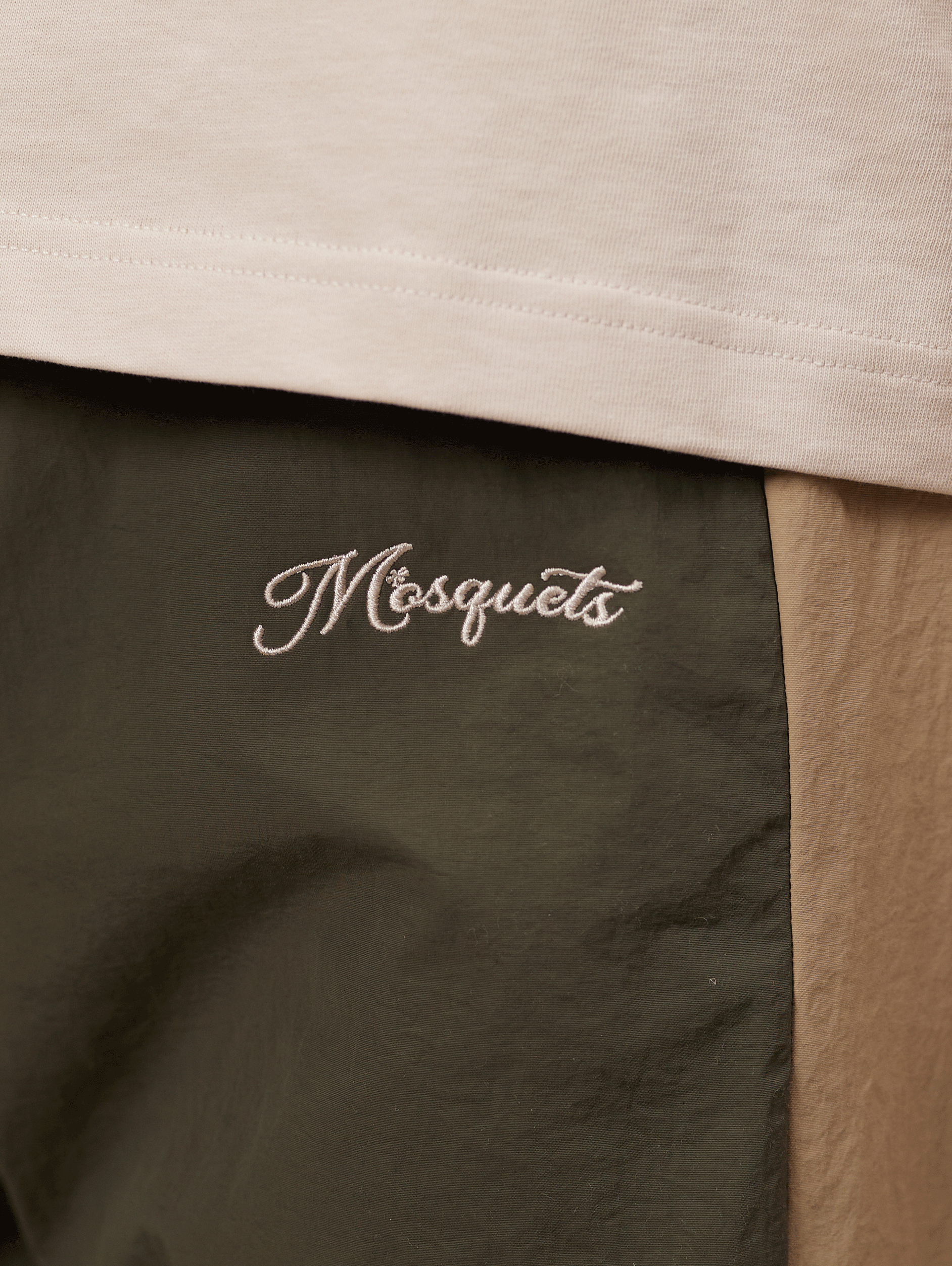 TWO-TONE TRACK PANTS WITH BEIGE EMBROIDERY AND NYLON GREEN ACCENTS