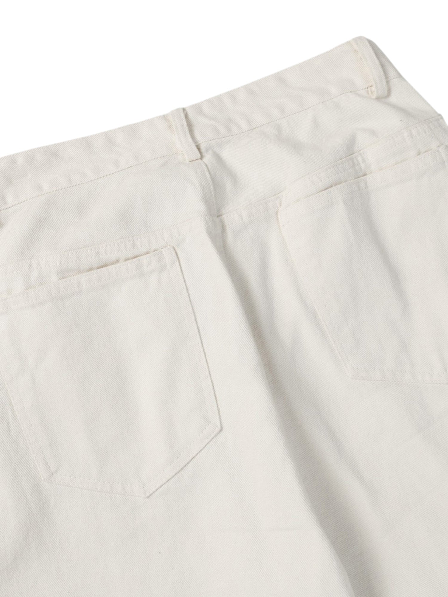 WASHED WHITE JEANS WITH DARK GRAY SPLOTCHES AND BLACK STAINS WASHED
