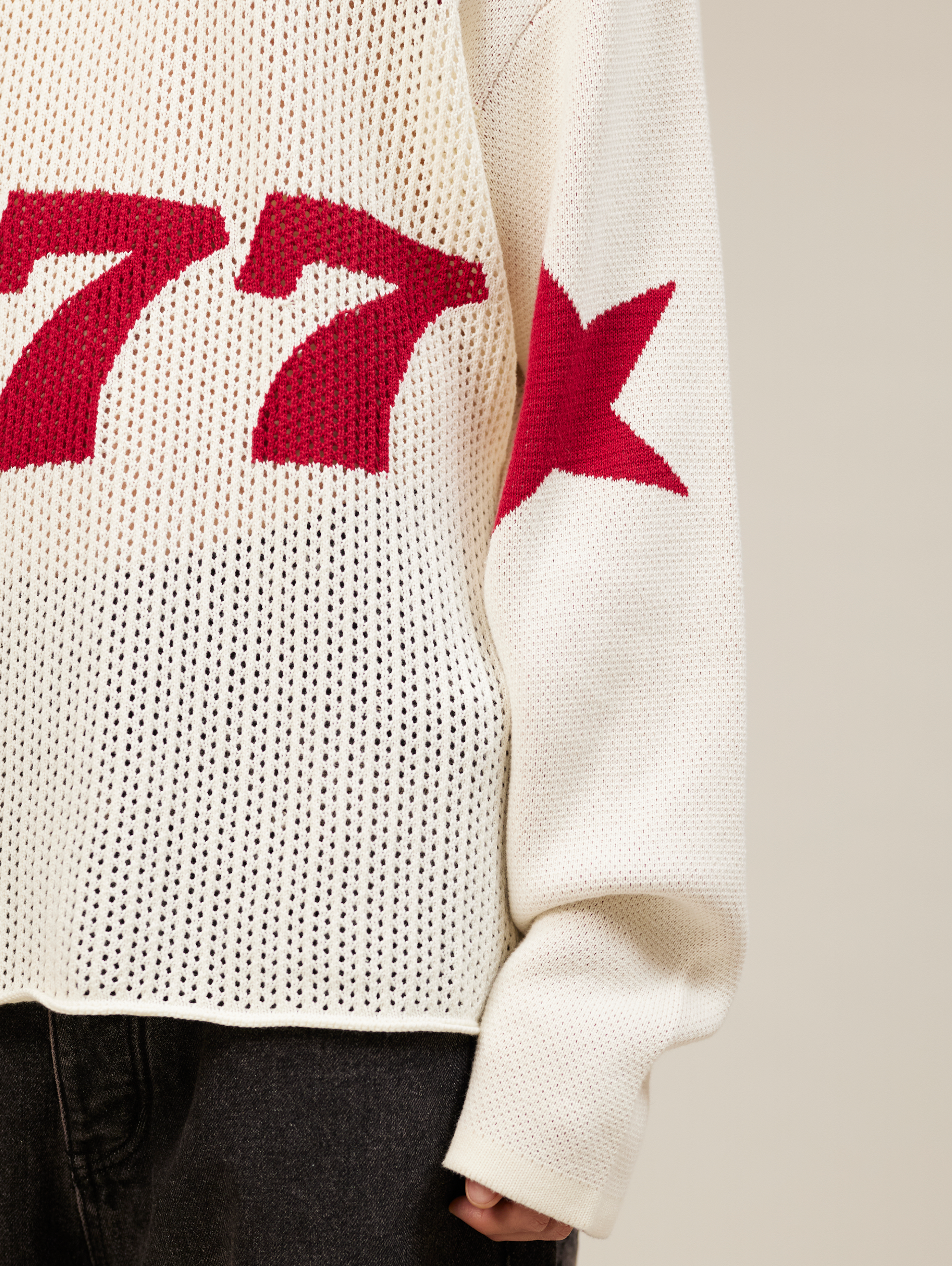 WHITE OVERSIZED KNIT SWEATER WITH RED STARS AND NUMBER 777