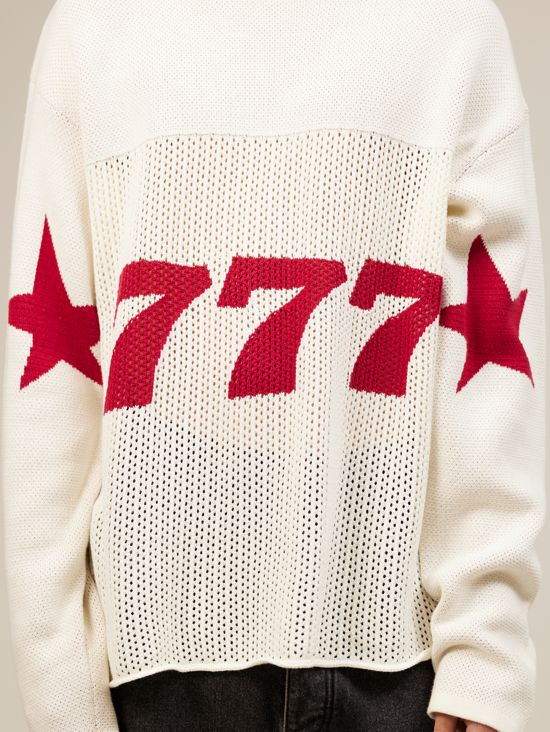 WHITE OVERSIZED KNIT SWEATER WITH RED STARS AND NUMBER 777
