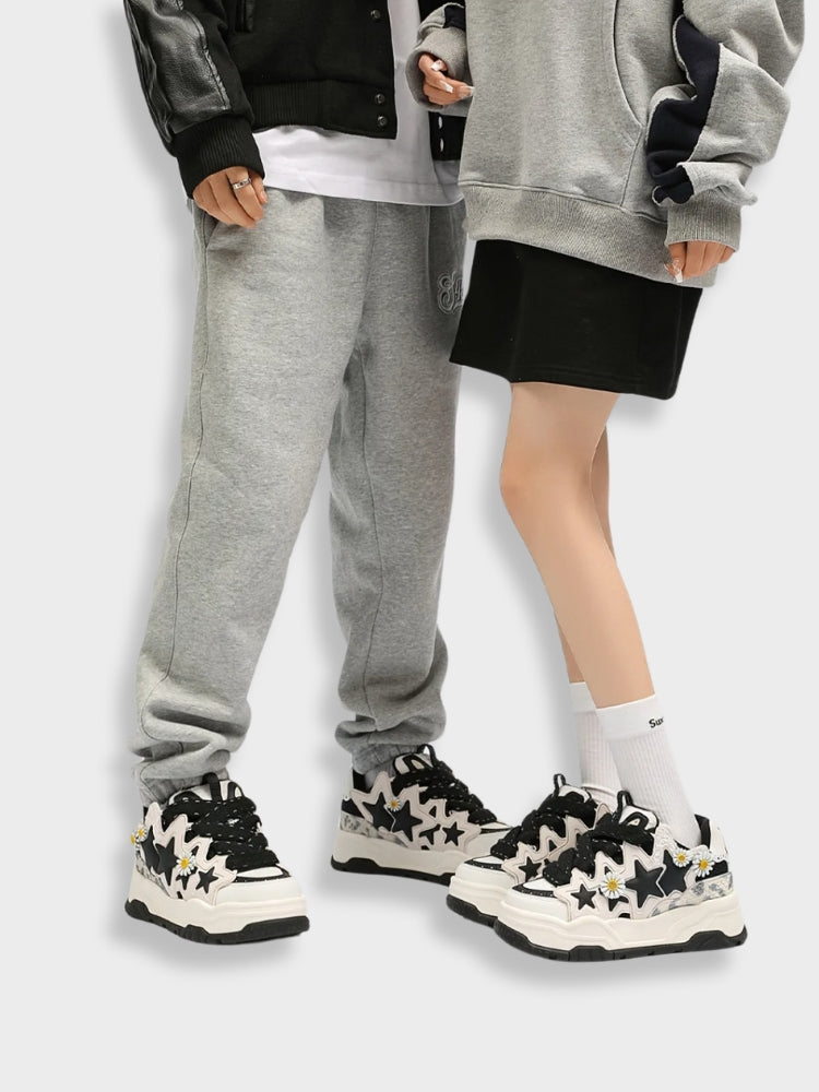 WHITE SNEAKERS WITH BLACK STAR ACCENTS VINTAGE TRIPLE STAR DESIGN